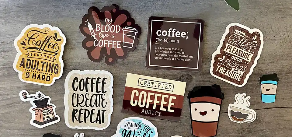 1980s Pop Culture Stickers A school notebook from the 1980s covered in puffy stickers, band logos, and neon shapes.