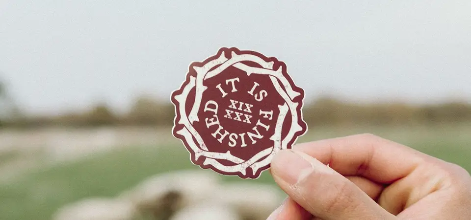 Modern Sticker Marketing A flat lay showing an open e-commerce box with a product, thank you card, and a branded die-cut sticker.