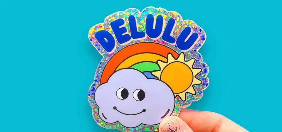 A collection of custom-shaped glitter stickers with different company logos printed on them.