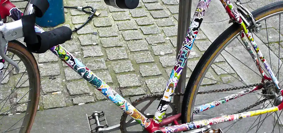 A collage of different custom bike stickers on various bikes