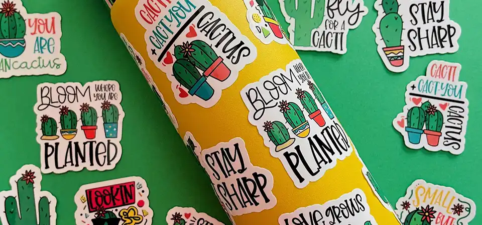 A flat lay of professional business marketing materials, including a die cut sticker, product box, and a unique card.