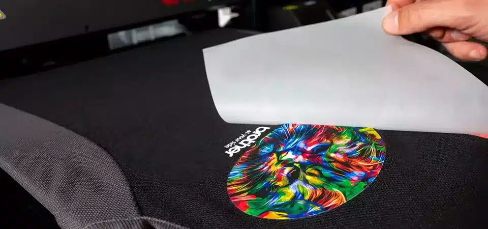 An illustration showing the steps of the DTF printing process from film to shirt