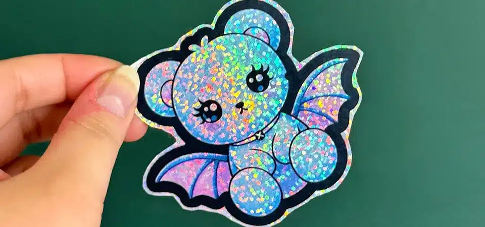 A macro photo of a glitter sticker showing the individual sparkly particles and textured surface.
