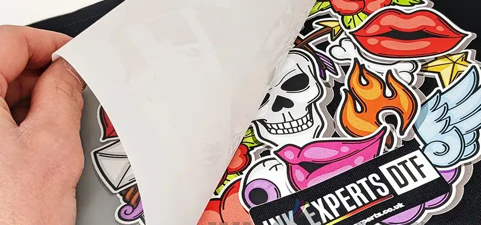 A collection of different items printed with DTF like a t-shirt, a tote bag, and a hat