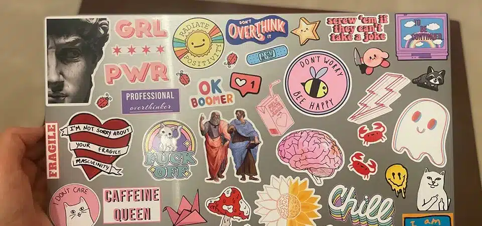 A close-up showing the texture of a matte vinyl sticker vs a paper sticker.