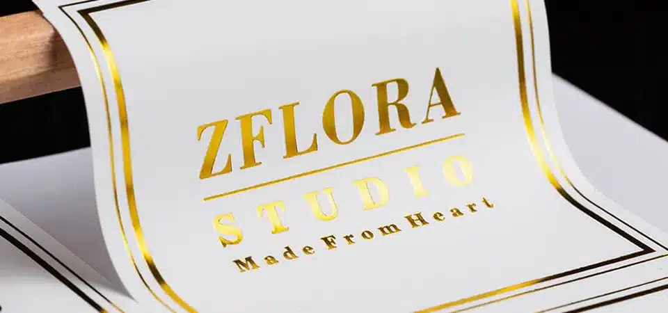 A split image comparing the debossed texture of hot foil to the flat finish of cold foil.