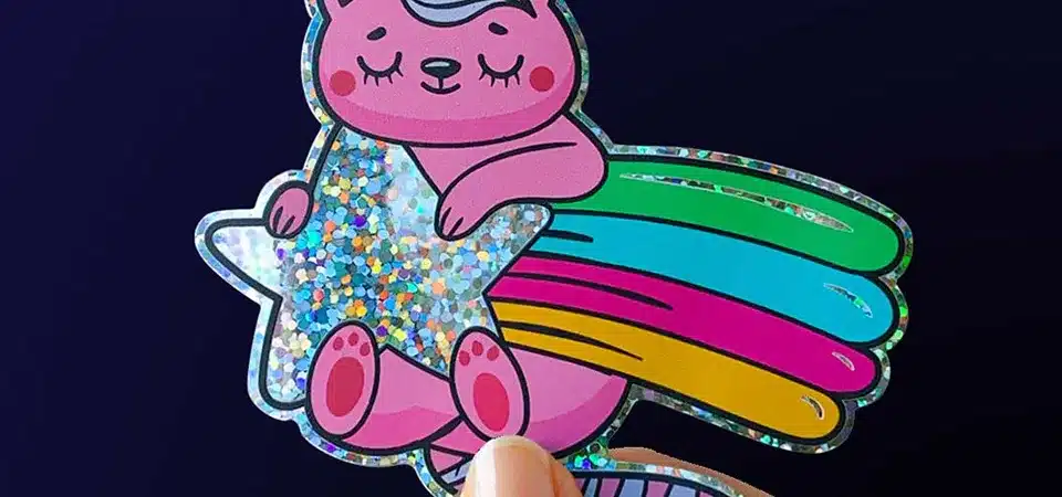 A close-up of a glitter sticker showing the individual sparkling flakes embedded in the material.