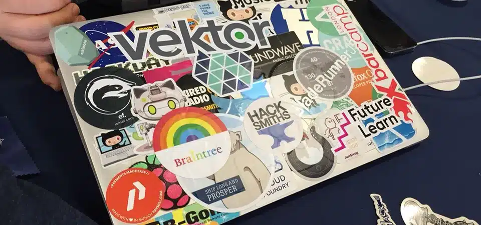 A sticker being peeled cleanly off a laptop, leaving no residue behind.