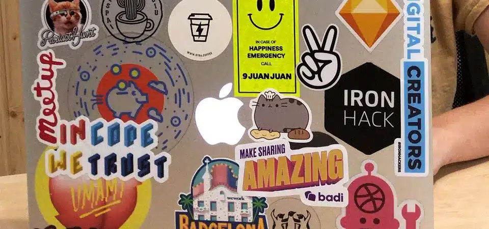 A laptop with a balanced collection of different sized stickers.
