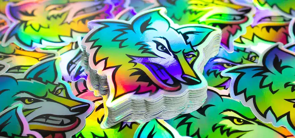 A sleek holographic logo sticker on a black tech gadget box.