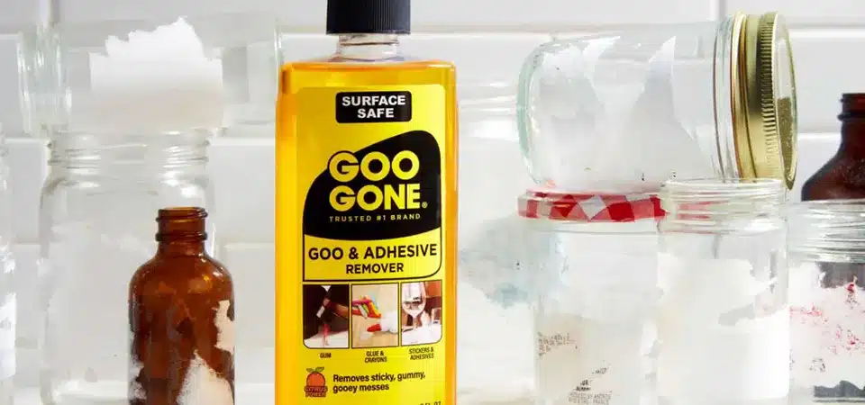 A bottle of Goo Gone next to a perfectly clean glass picture frame.