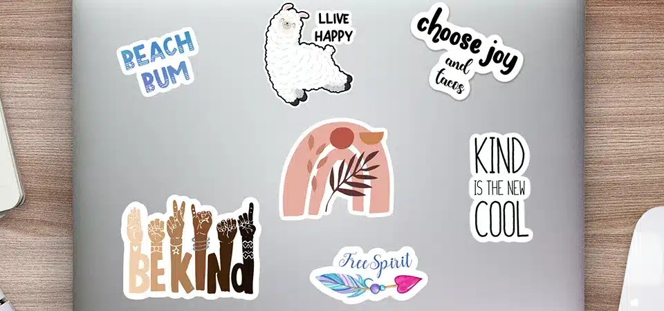 A table with sticker application tools: rubbing alcohol, a cloth, and a squeegee