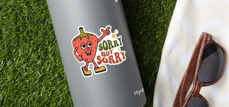A sticker on a curved water bottle next to a flat thermal lamination machine with a red X over it
