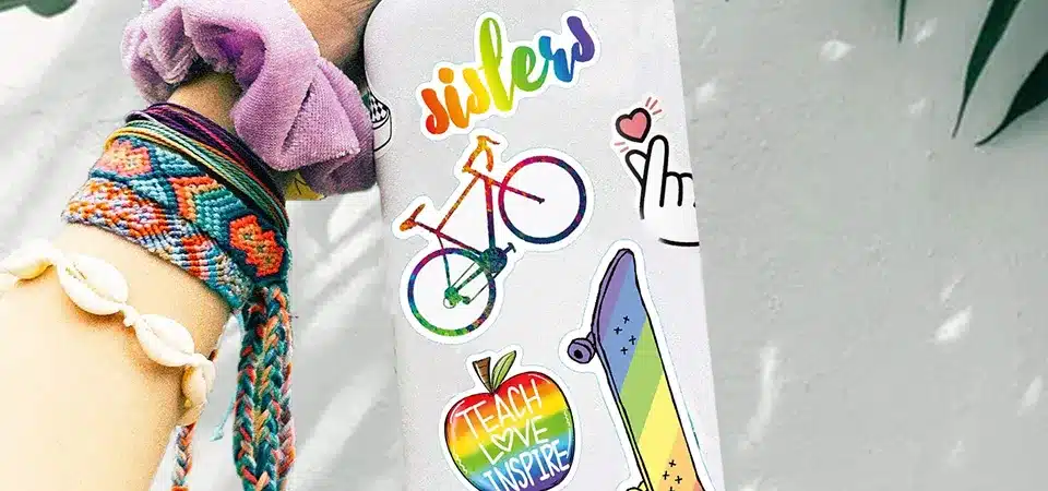 A close-up diagram showing the layers of a quality vinyl sticker: laminate, ink, and vinyl base