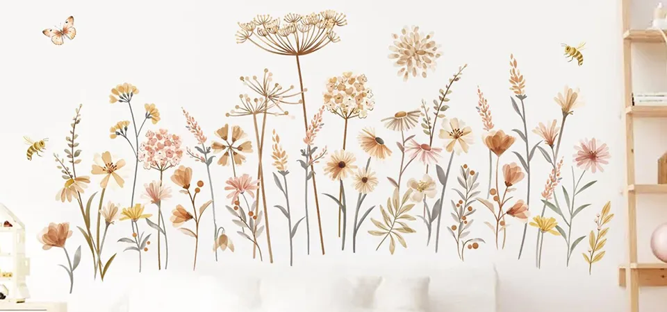 A sticker collage artfully arranged on a white canvas hanging on a wall