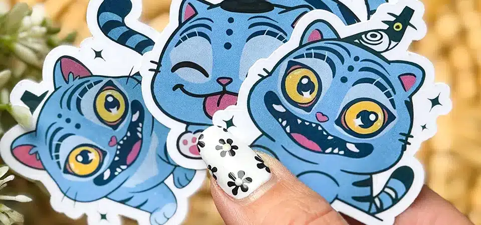 A colorful arrangement of reusable stickers displayed on a clear acrylic board on a desk