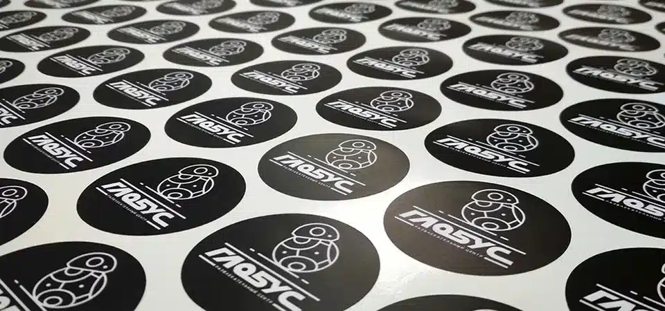 An assortment of high-quality stickers showing different finishes, including holographic, matte, and clear vinyl