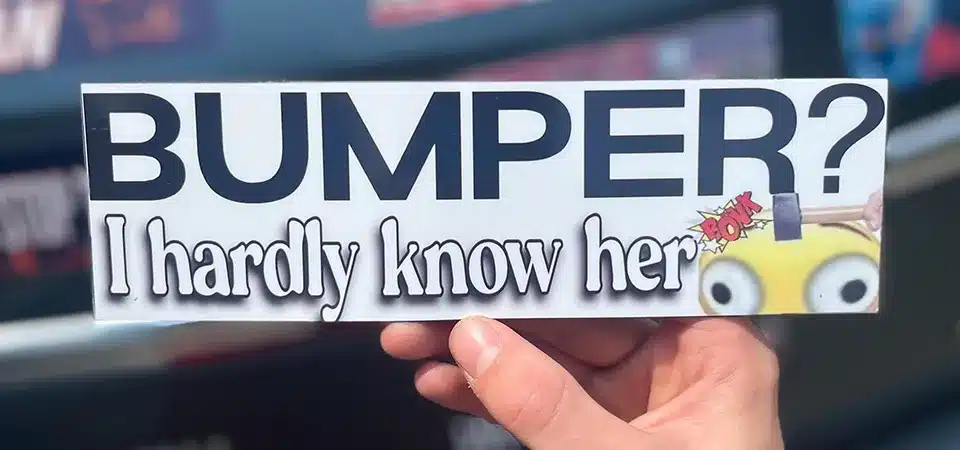 A ruler measuring a classic 3" x 11.5" bumper sticker