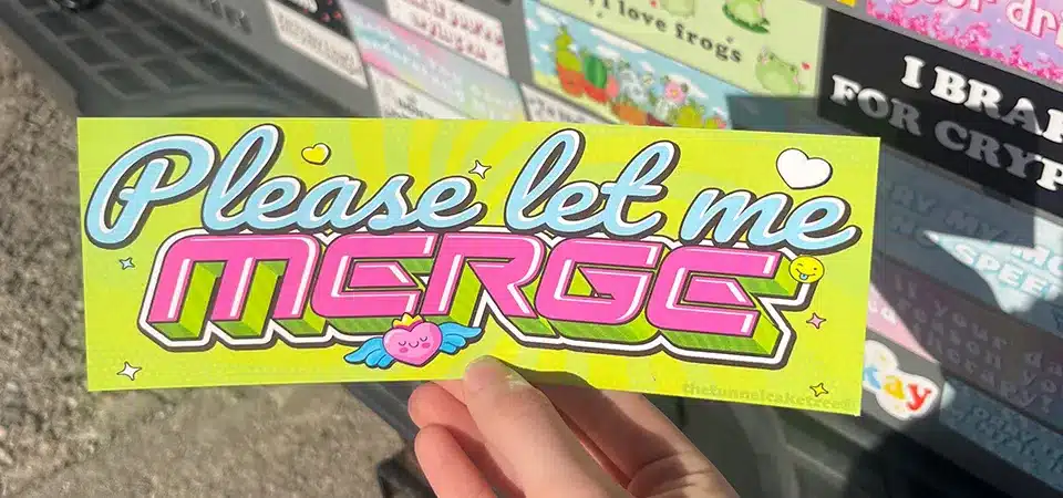 A standard-sized bumper sticker on the back of a car