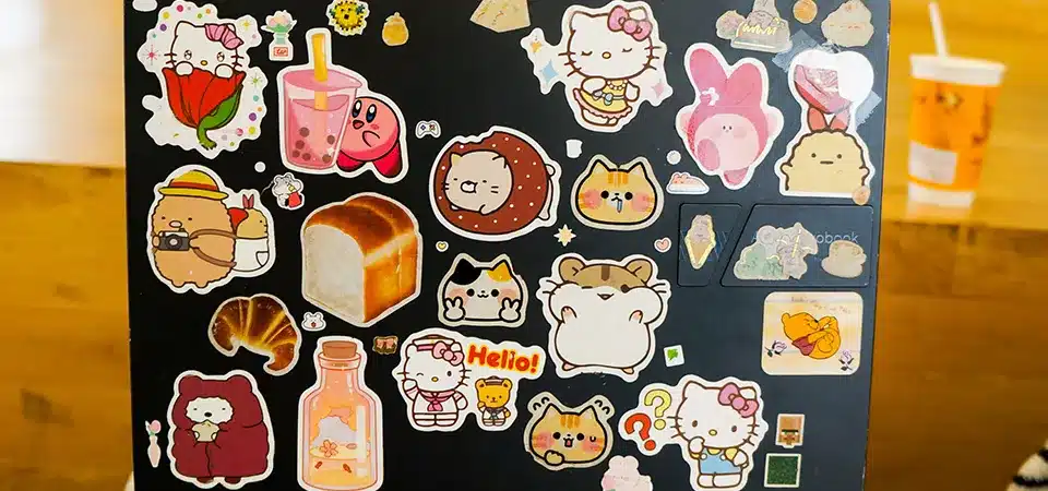 Side-by-side comparison of a sticker book, wax paper, and plastic sheet protectors