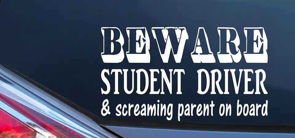 A car from behind showing ideal placement spots for a student driver sticker on the bumper and rear window