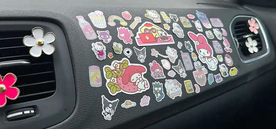 A close-up shot showing a vinyl sticker being peeled off a car with no damage underneath