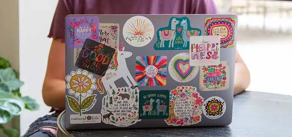 A clear laptop skin being applied before adding stickers