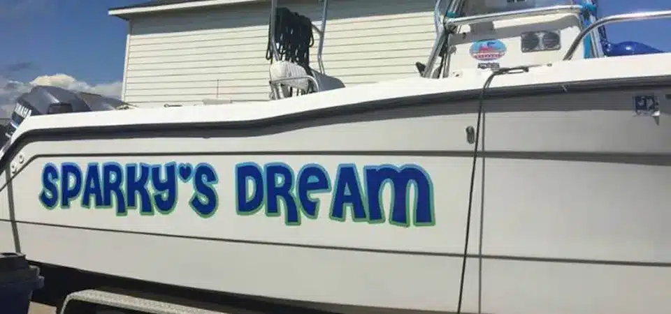 A half-polished boat hull showing a ghost image being buffed out