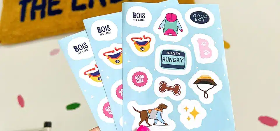 A branded sticker sheet for a small business with logos, thank you notes, and social media handles
