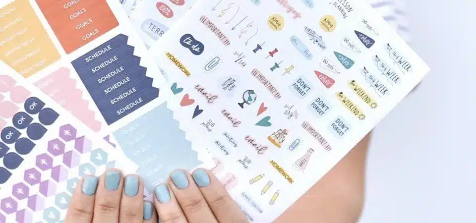 A functional planner sticker sheet with day labels, habit trackers, and various small icons