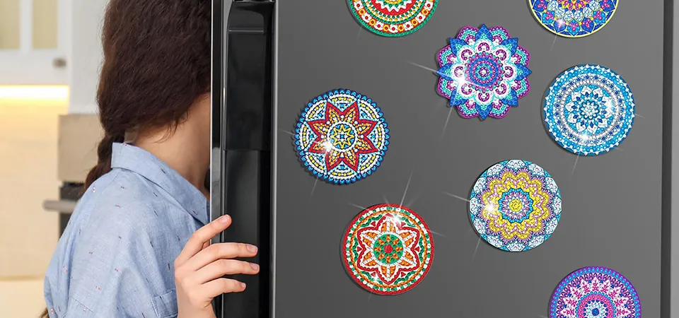 A fridge door arranged like an art gallery wall, with magnets featuring famous paintings and abstract art