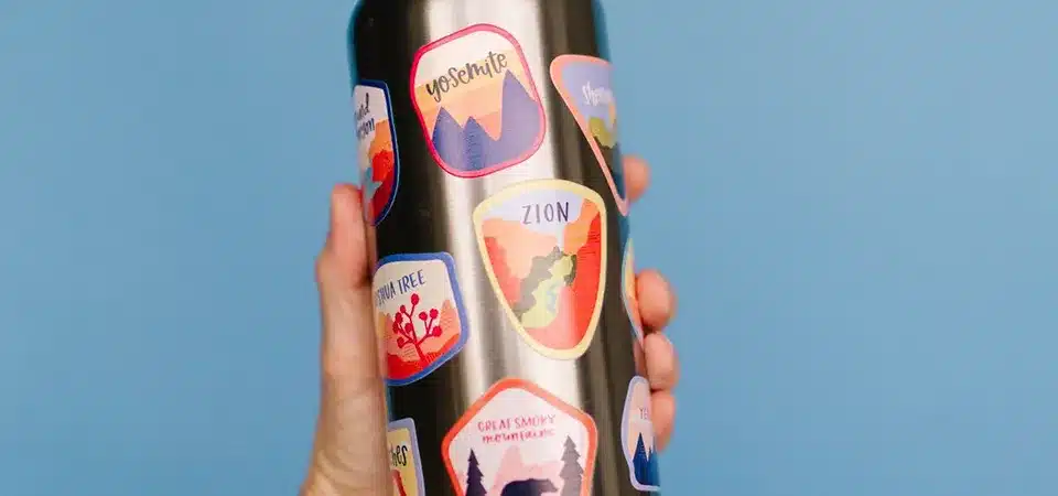 A thermal laminator machine with a sticker sheet in a pouch feeding into it