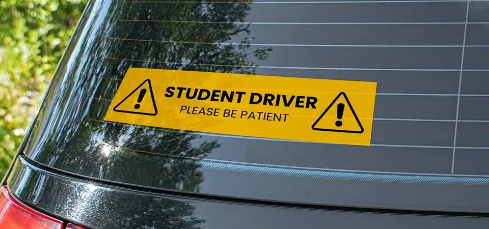 A die-cut vinyl text sticker on the rear window of an SUV