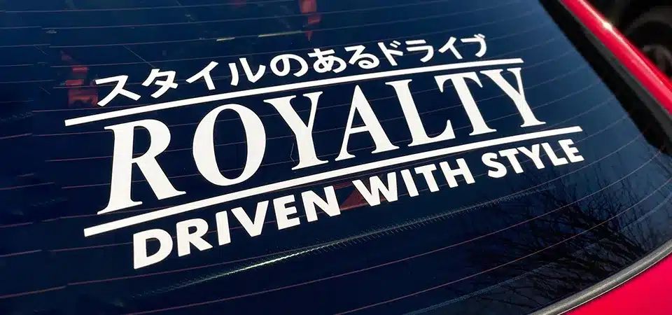 A small decal sticker placed in the corner of a car's windscreen