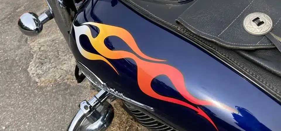 A custom graphic sticker on the side of a motorcycle's gas tank