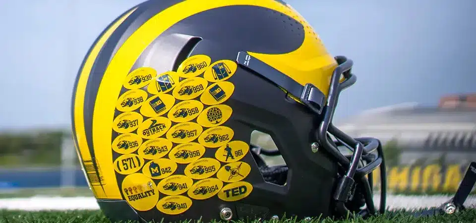 what do the stickers on college football helmets mean
