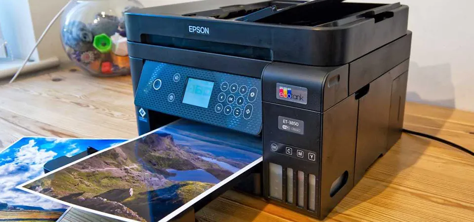 A close-up shot of a sticker sheet coming out of an Epson EcoTank printer