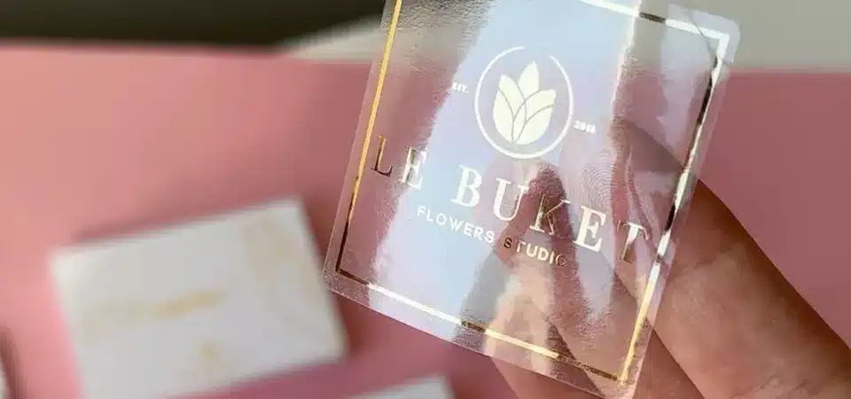 A collection of custom-cut clear stickers in different shapes like a star, a logo, and a circle
