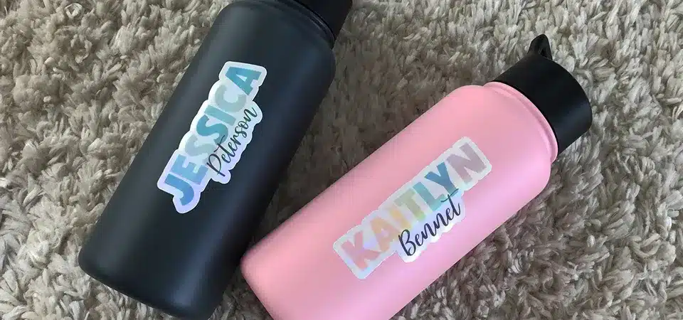 A waterproof sticker submerged in water vs. a water-resistant sticker with water beading on top