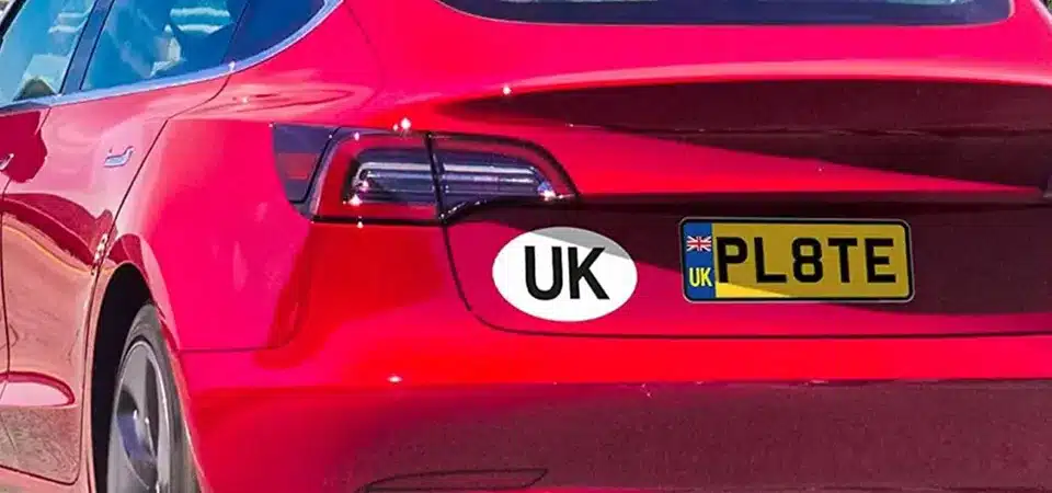 A display of UK car stickers and other travel accessories for sale in a shop at a ferry terminal