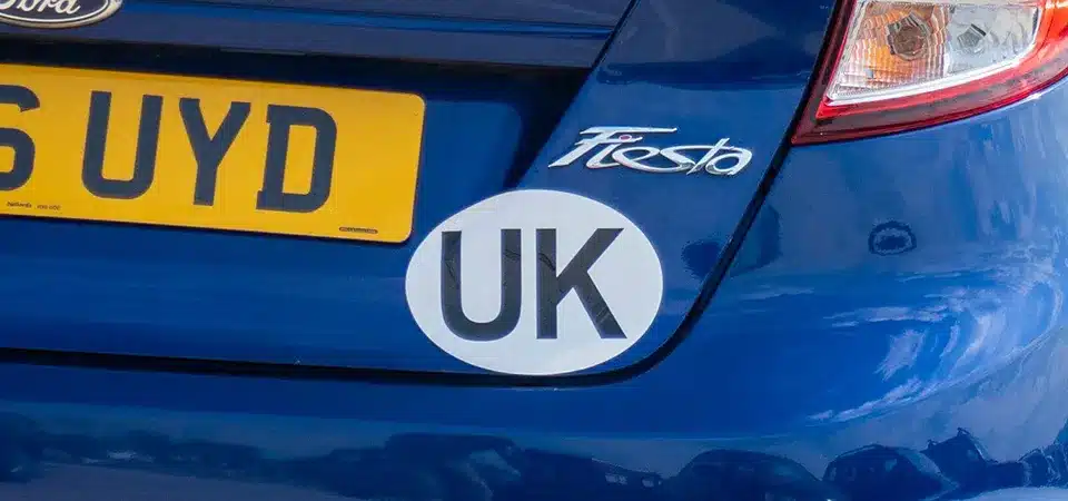 A police officer talking to a driver in a UK registered car in Europe