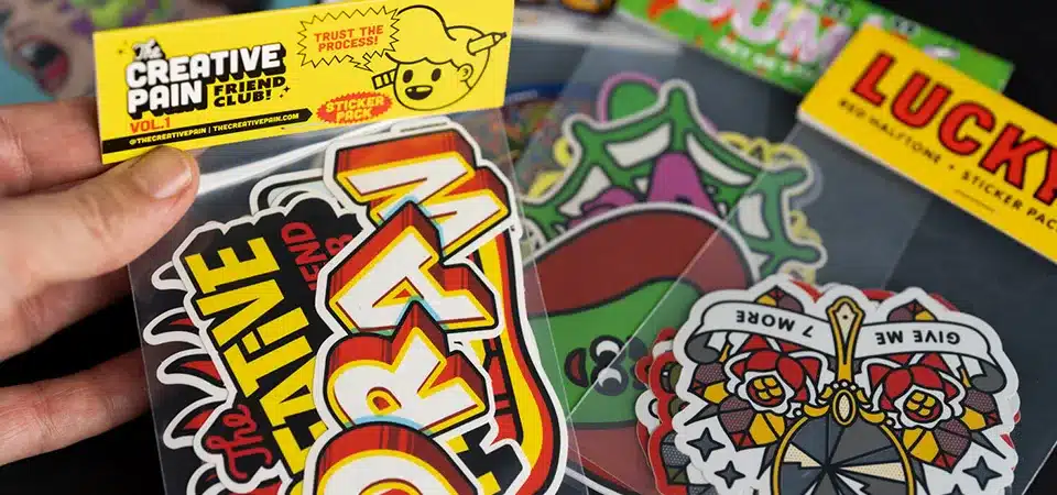 A laptop covered in various branded and artistic stickers