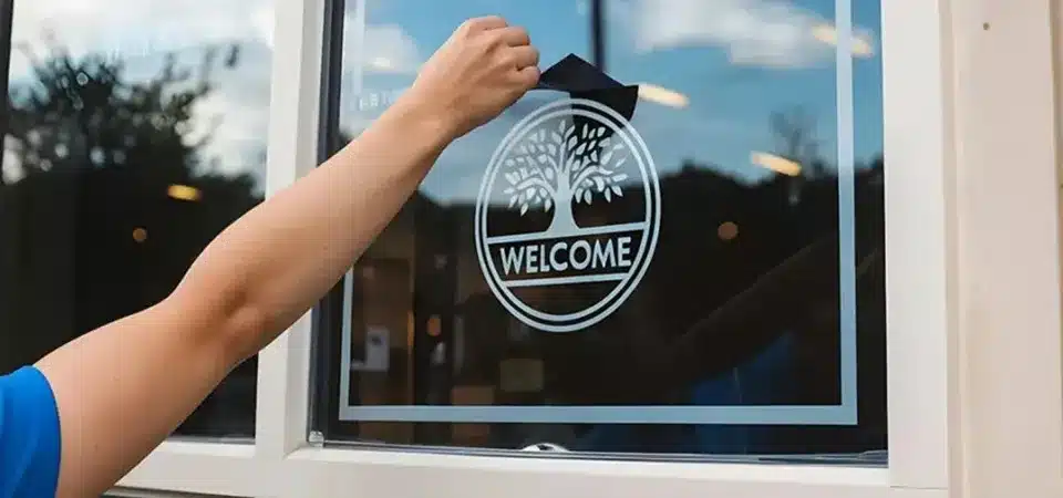 A paste of baking soda being applied to a window with a cloth