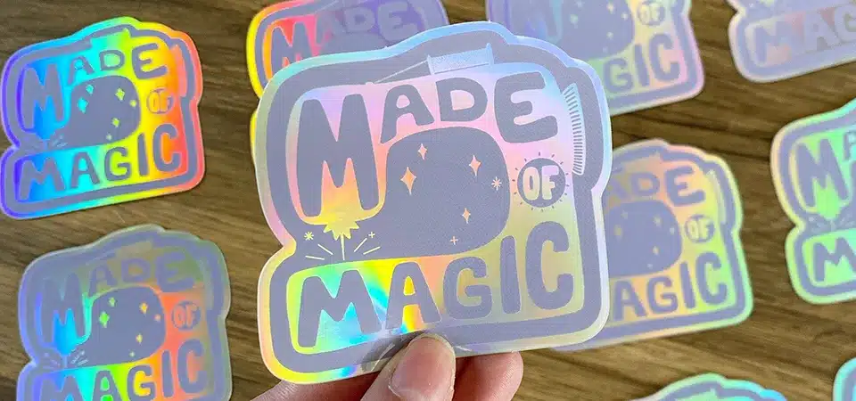 The Layers of a Holographic Sticker A diagram showing the layers of a holographic sticker: vinyl, print, and laminate