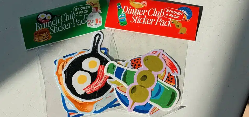 Arranging Sticker Designs on a Print Sheet A GIF showing multiple sticker designs being arranged on a digital canvas