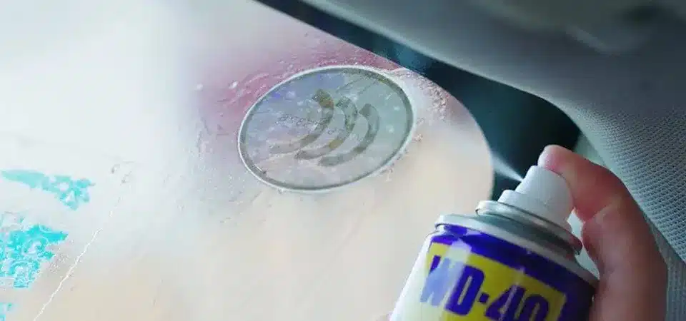 A can of WD-40 next to a microfiber cloth, ready to be applied to a mirror surface