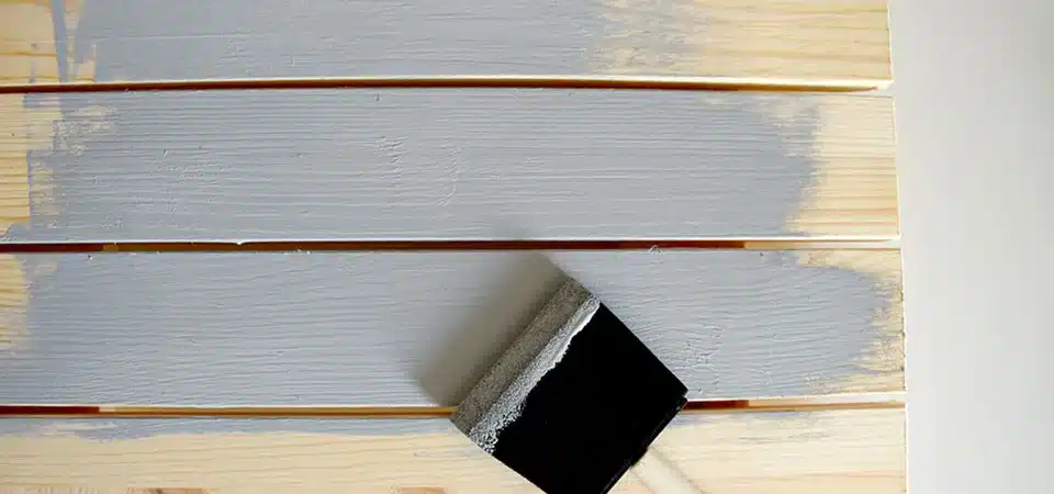 A side-by-side comparison of Mod Podge, acrylic spray, and epoxy resin finishes on wood