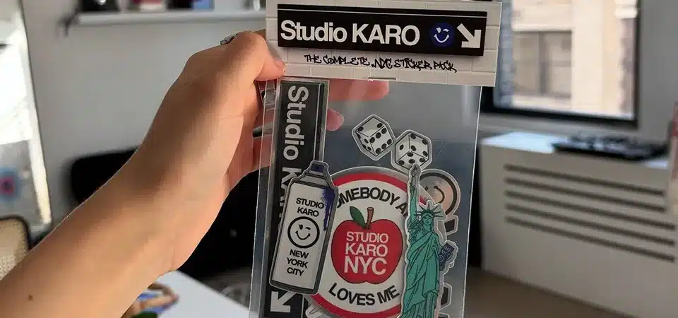 A customer happily unboxing an order that includes a free sticker pack