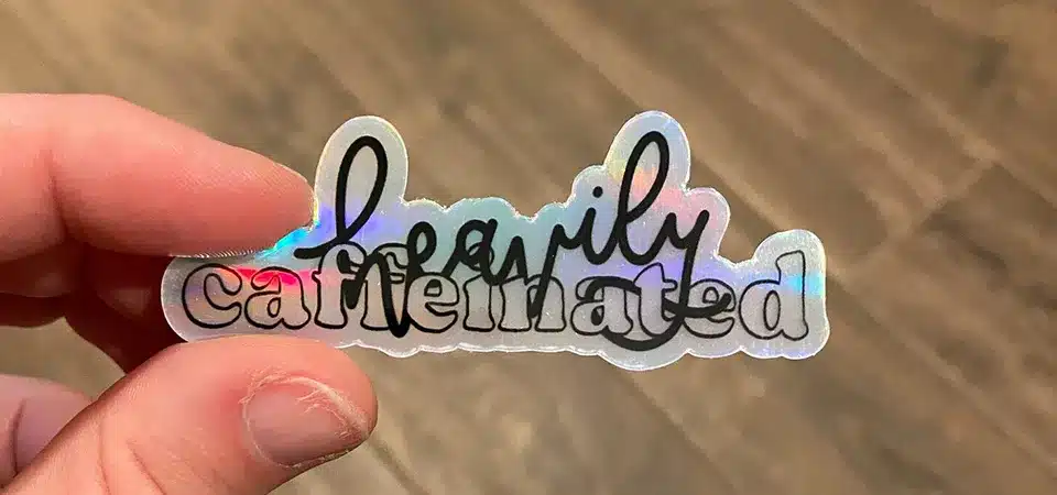 An energy coffee company's holographic sticker with a fist icon