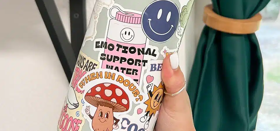 An image comparing a non-laminated vinyl sticker with smeared ink against a laminated one that is perfectly intact after getting wet